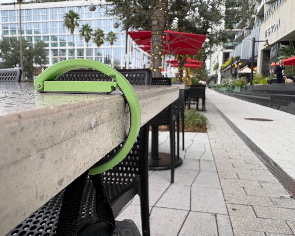 Clingy everyday hook securely hanging a bag from a table edge